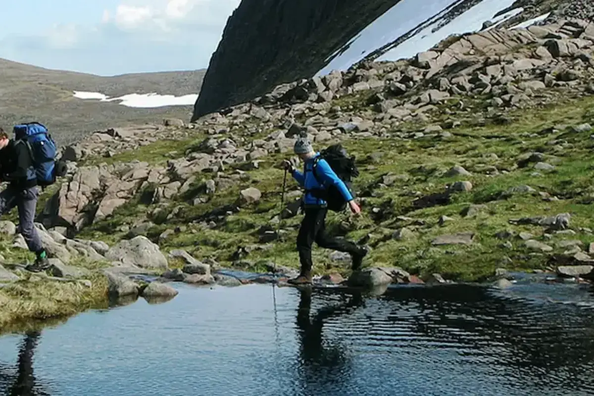 Gordonstoun students on an expedition in the mountains, hiking around a tarn