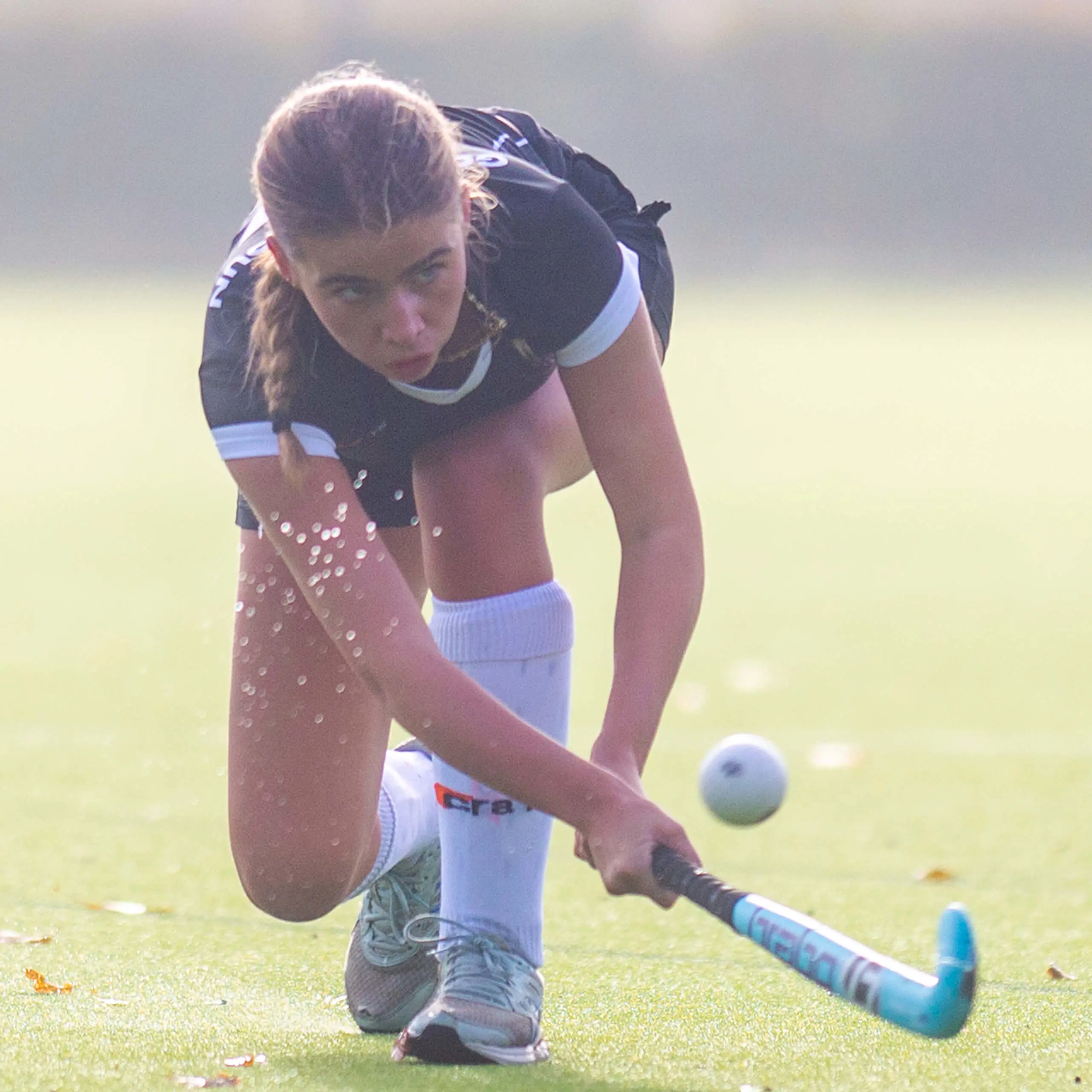 A Gordonstoun hockey player making a sweeping shot on goal during a match on the school’s astro turf.