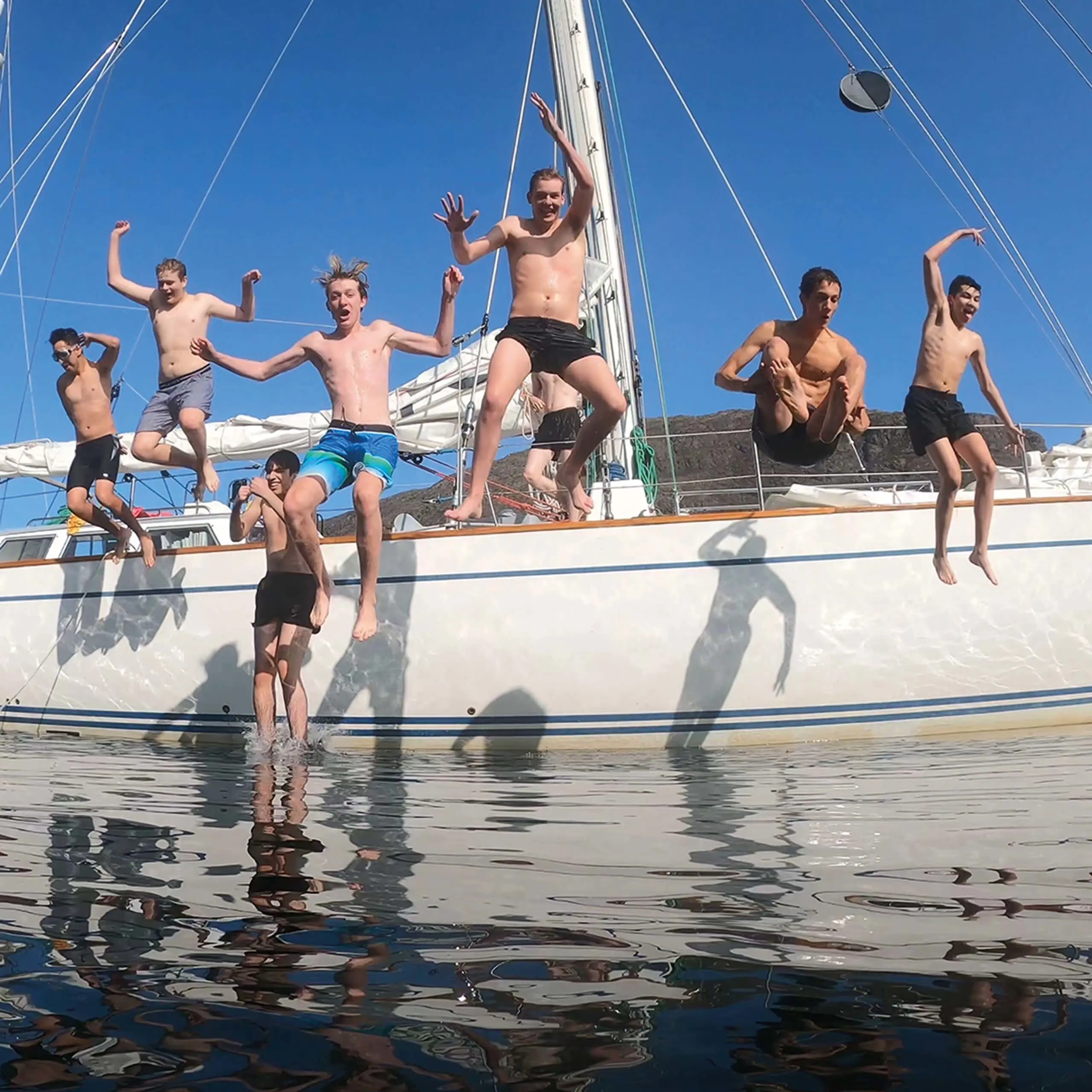 Gordonstoun students jumping off Ocean Spirit of Moray, the School’s own sail training vessel.