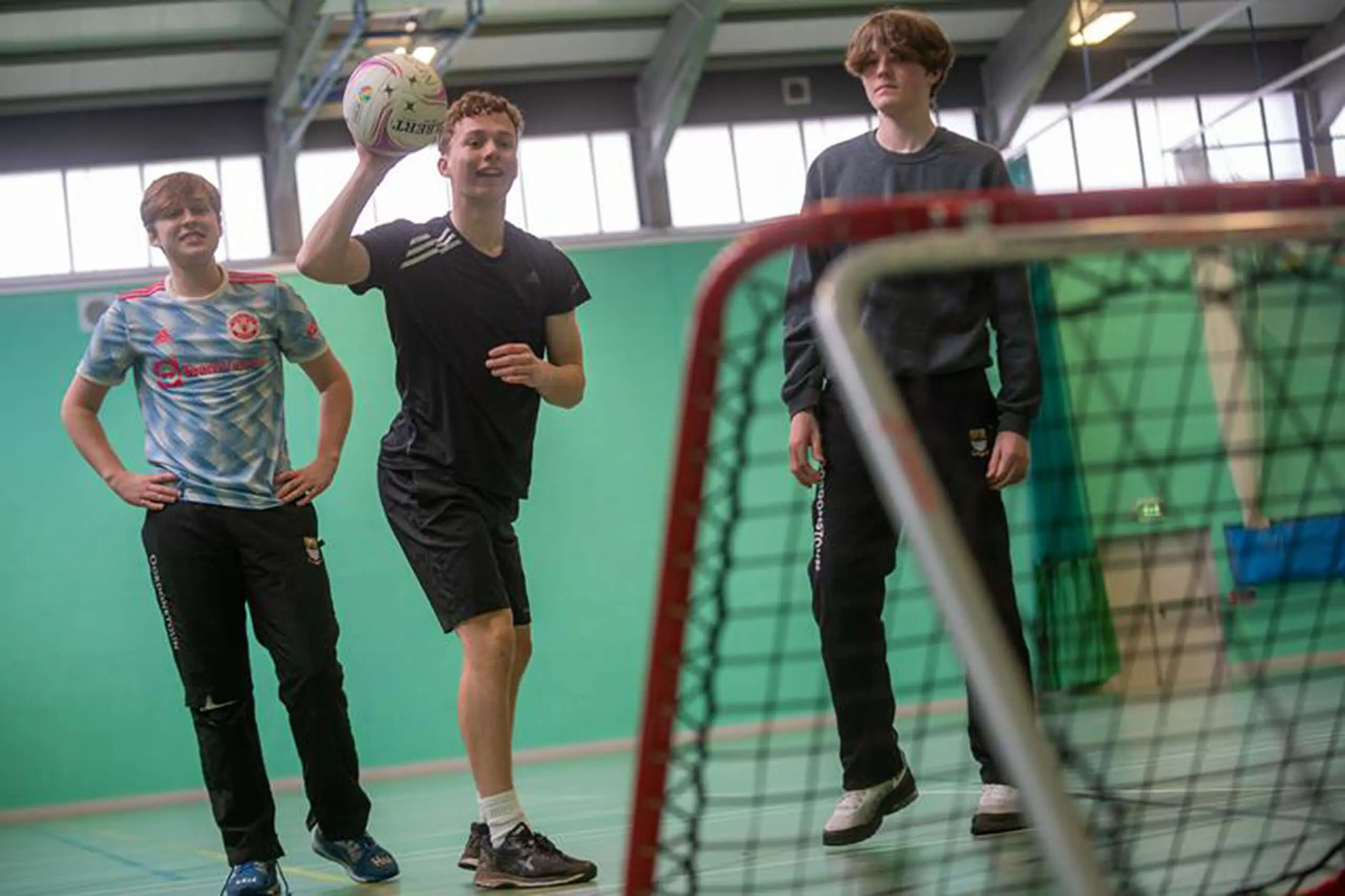  Three students playing a ball game