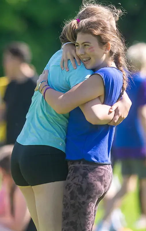 Gordonstoun pupils hugging at an athletics competition