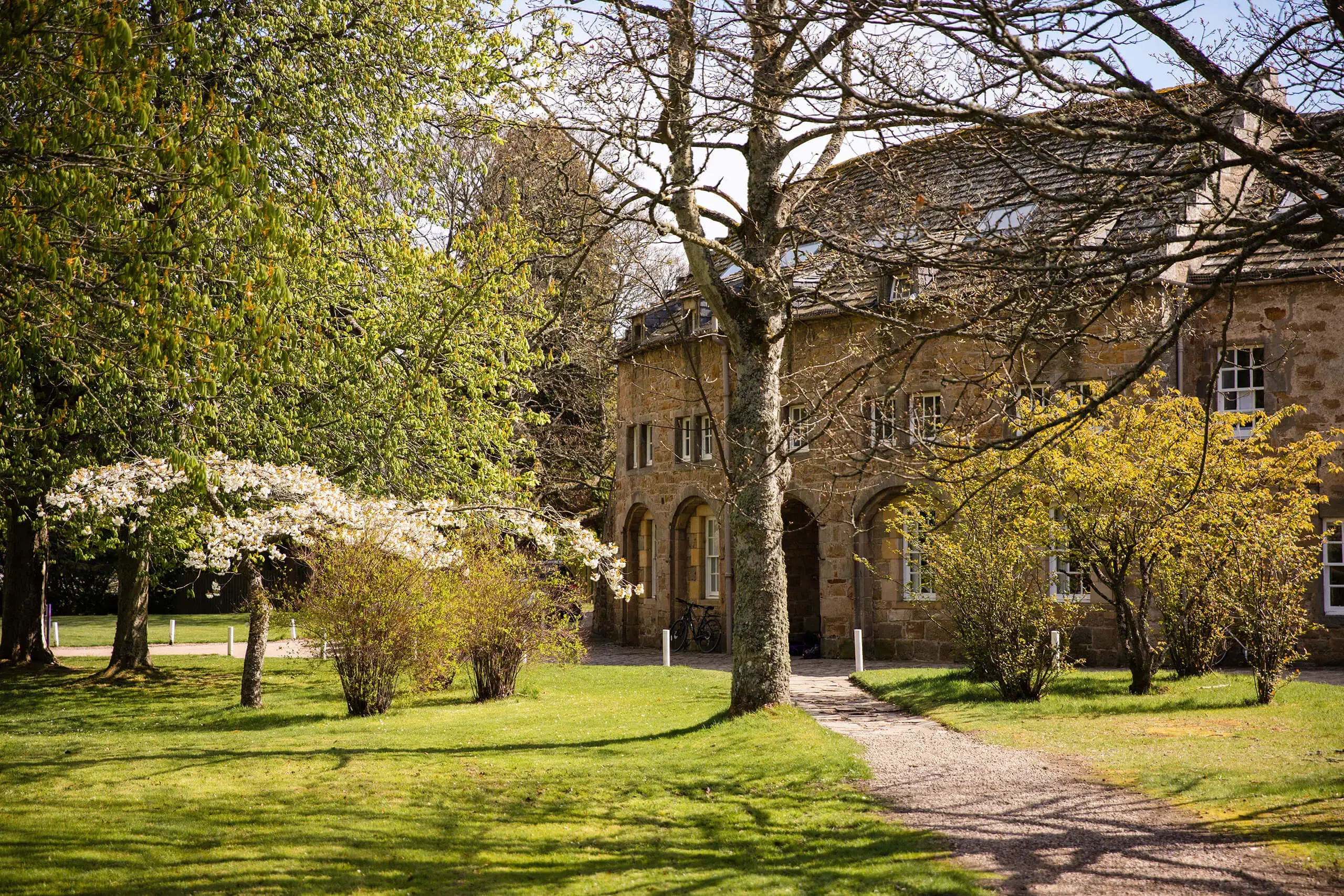 Round square, one of Gordonstoun’s iconic and historic buildings through the trees in spring.