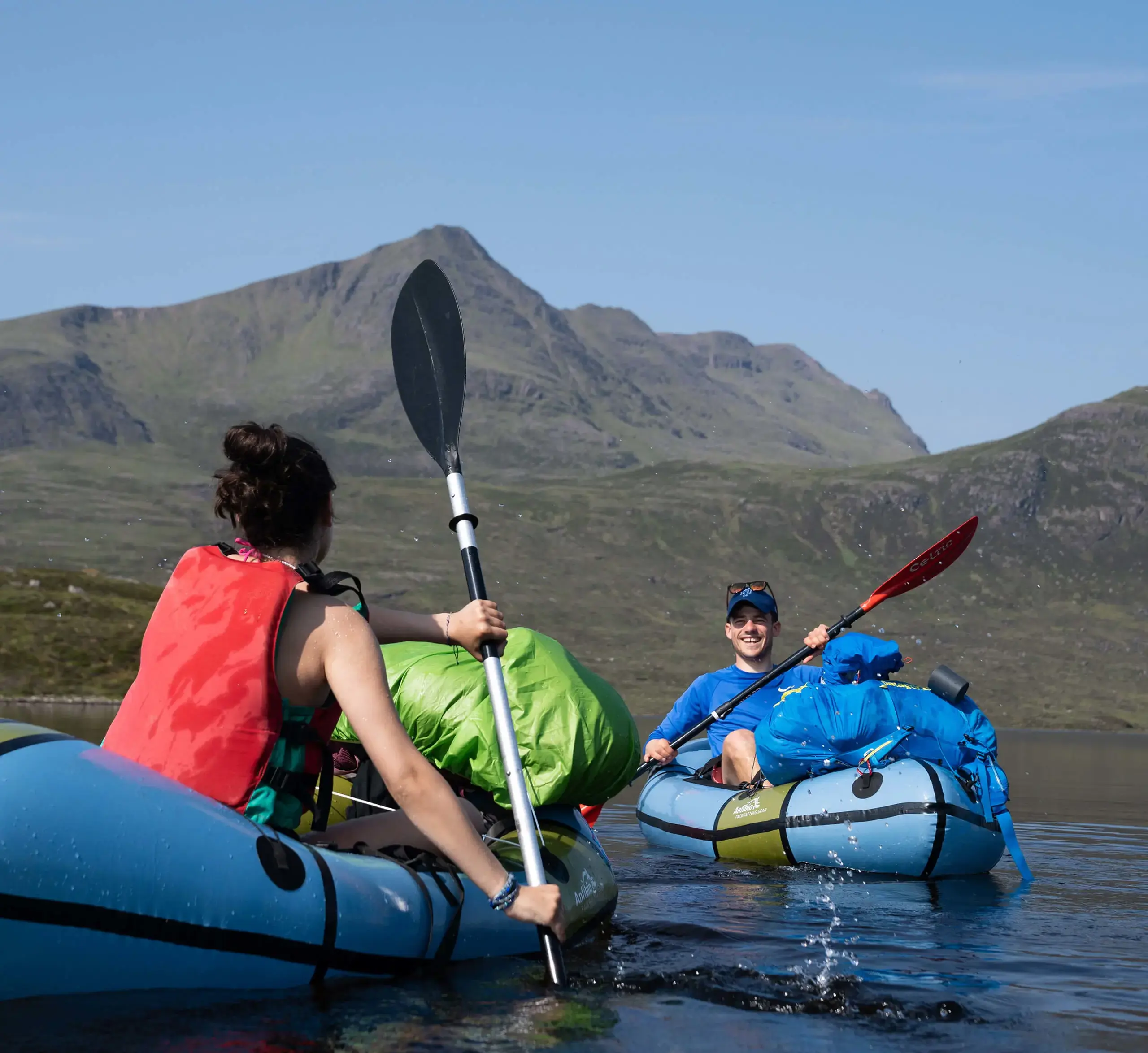 Gordonstoun staff member splashing around in canoes with Gordonstoun students, laughing.