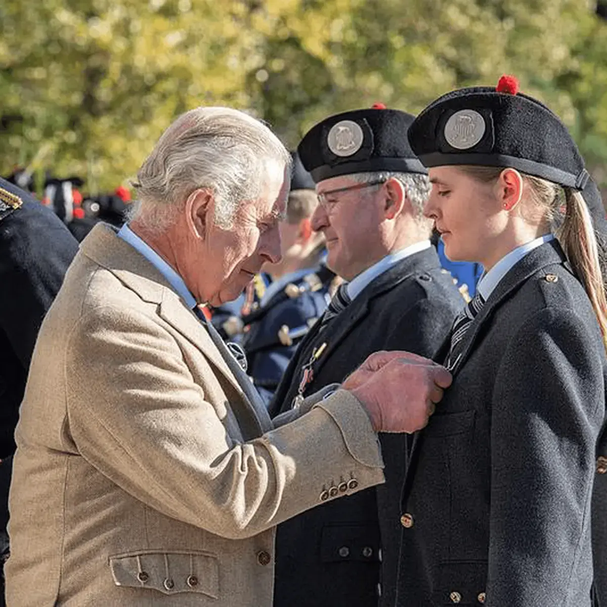 Gordonstoun pipers receiving their coronation medals by HM The King