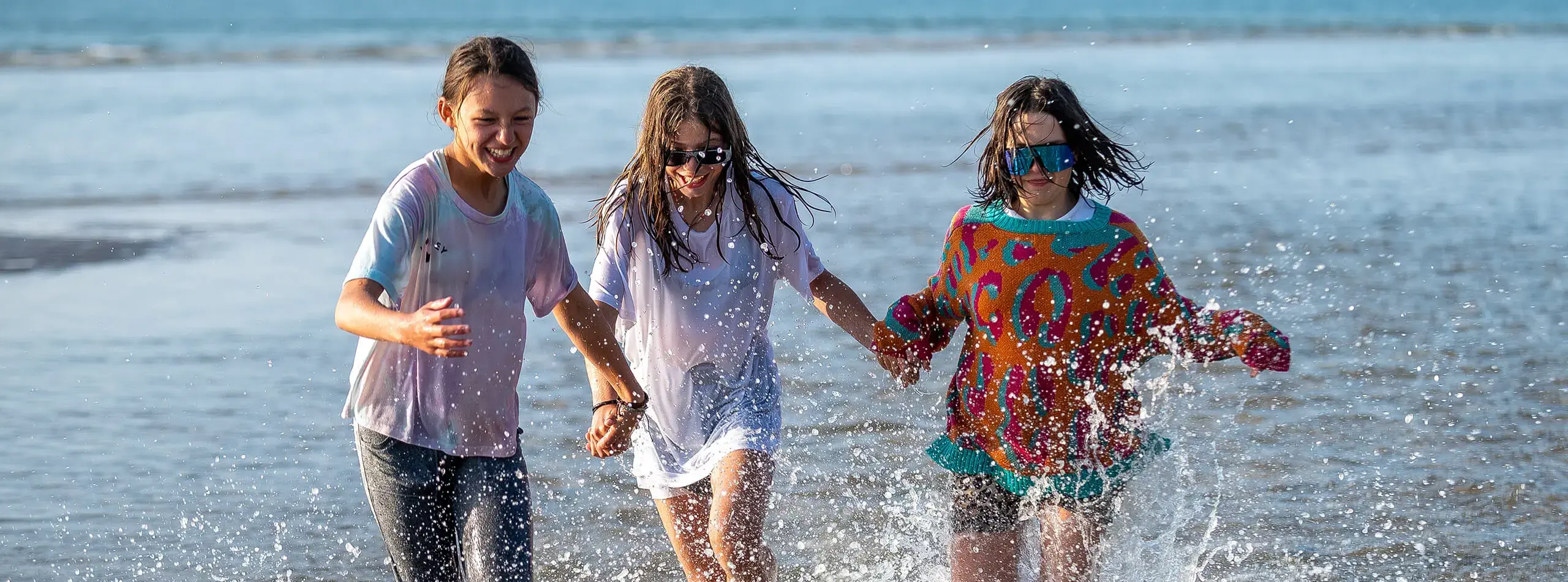 Happy smiley students run on Moray Beach