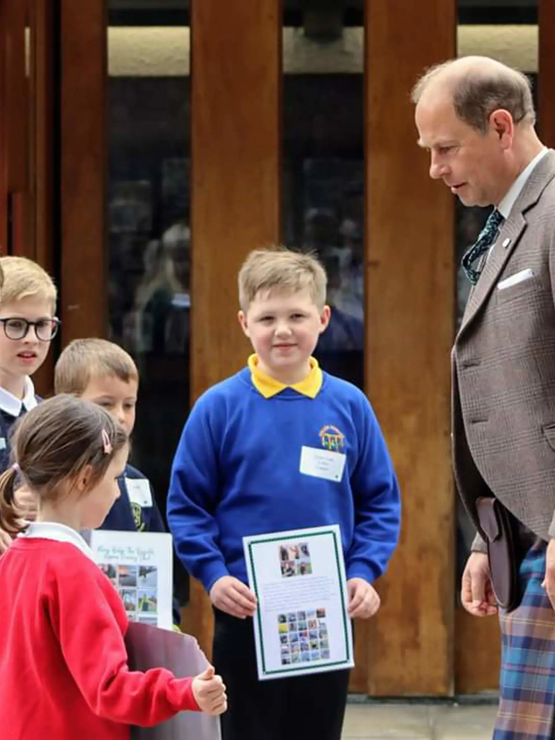 HRH The Duke of Edinburgh, Prince Edward, with local Moray Primary School Children, looking at board of their work towards earning their moray badge.