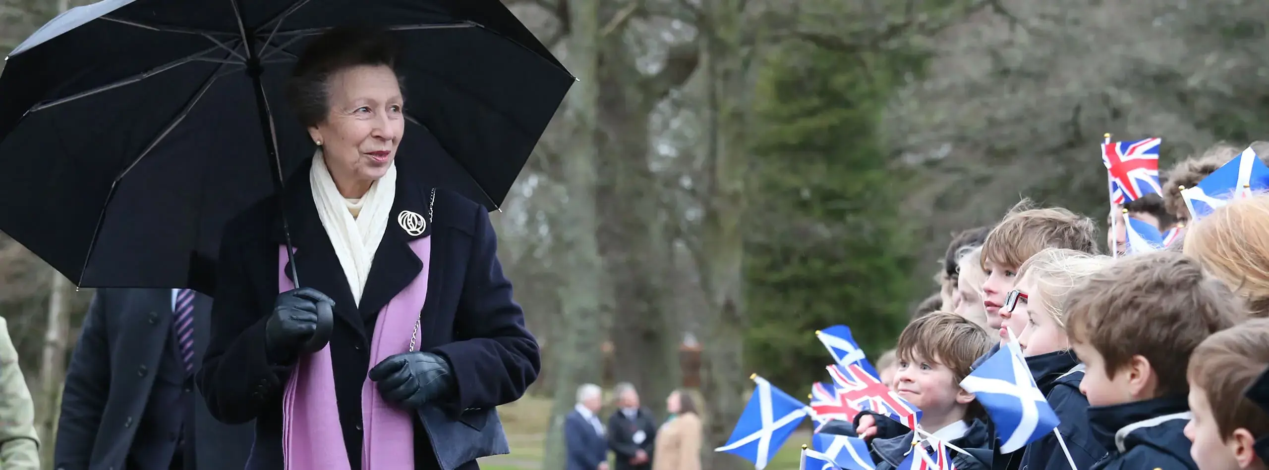 Gordonstoun’s prep students lined up waving flags on campus for HRH The Princess Royal.