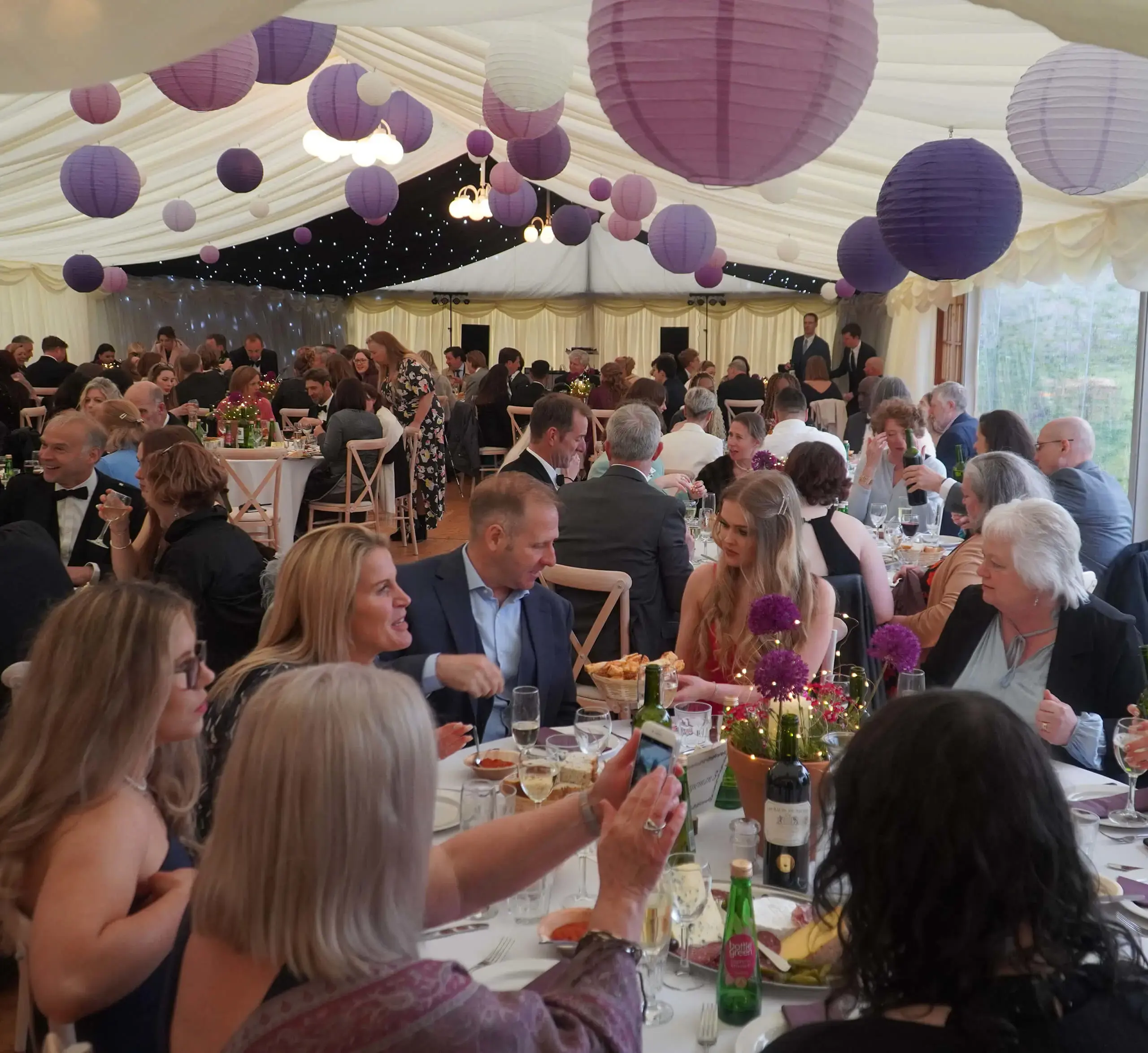 Possible families having a meal in a marquee on the grounds of Gordonstoun