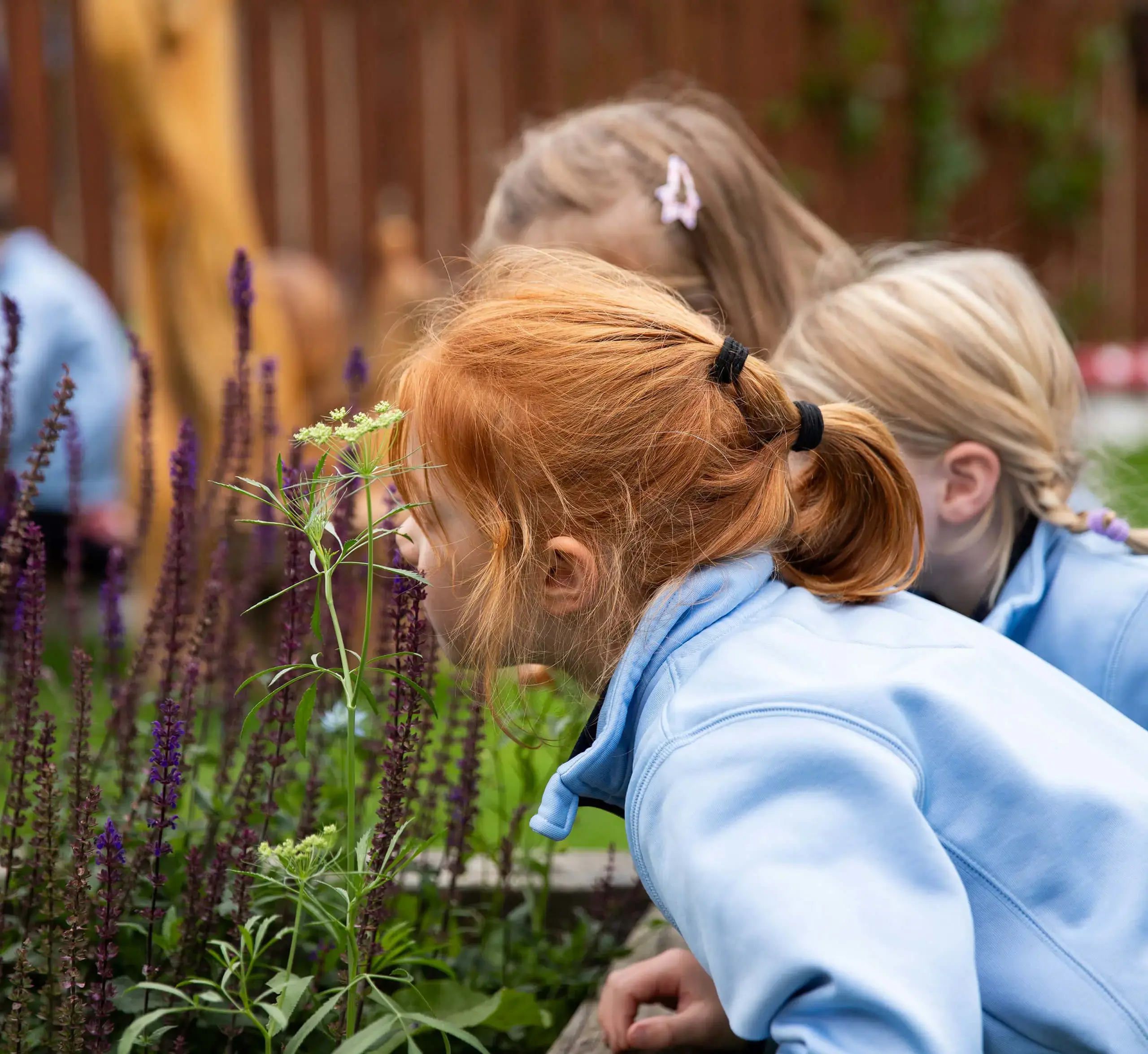 Young learners using their senses in the play garden