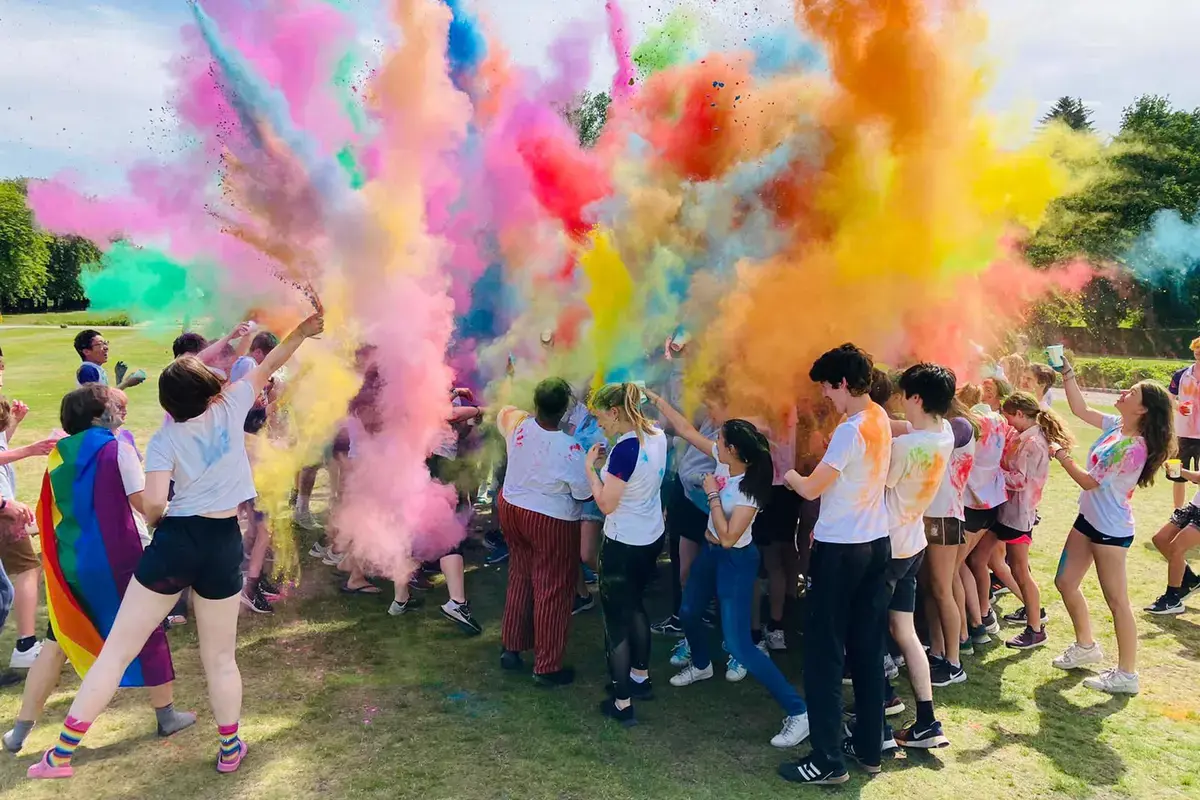 A range of students from all over the whole have fun throwing colourful powder in a colour run event at Gordonstoun