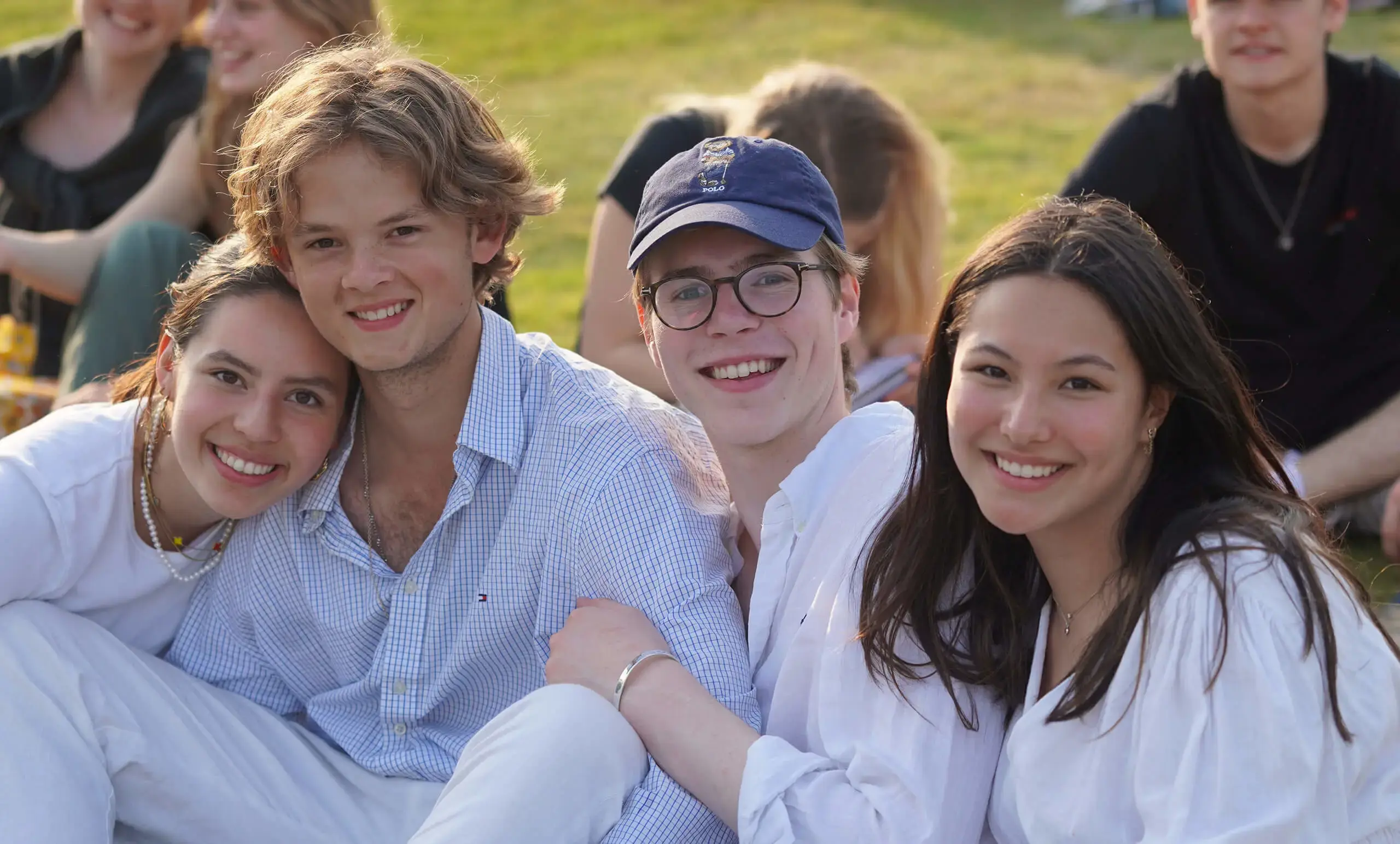 Four happy Gordonstoun students relaxing outside