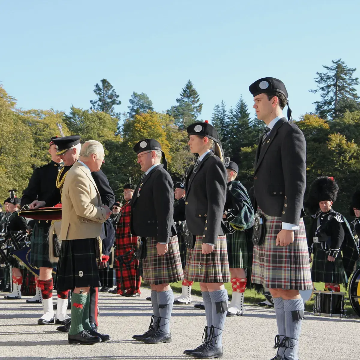 Gordonstoun pipers receiving their coronation medals by HM The King