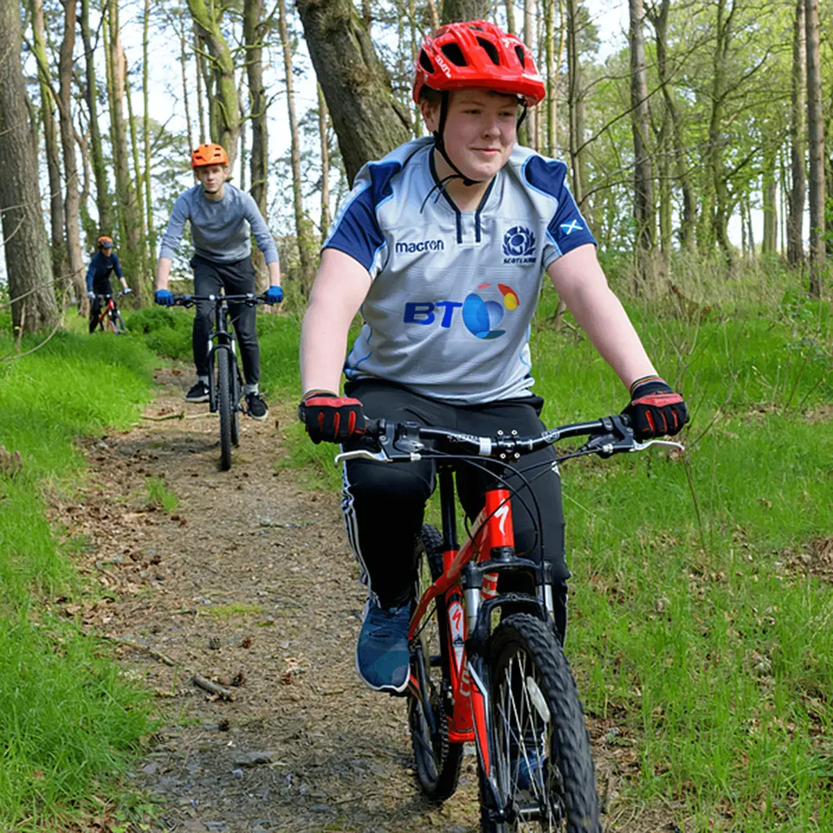 Student Riding Bike Through Forest Trail