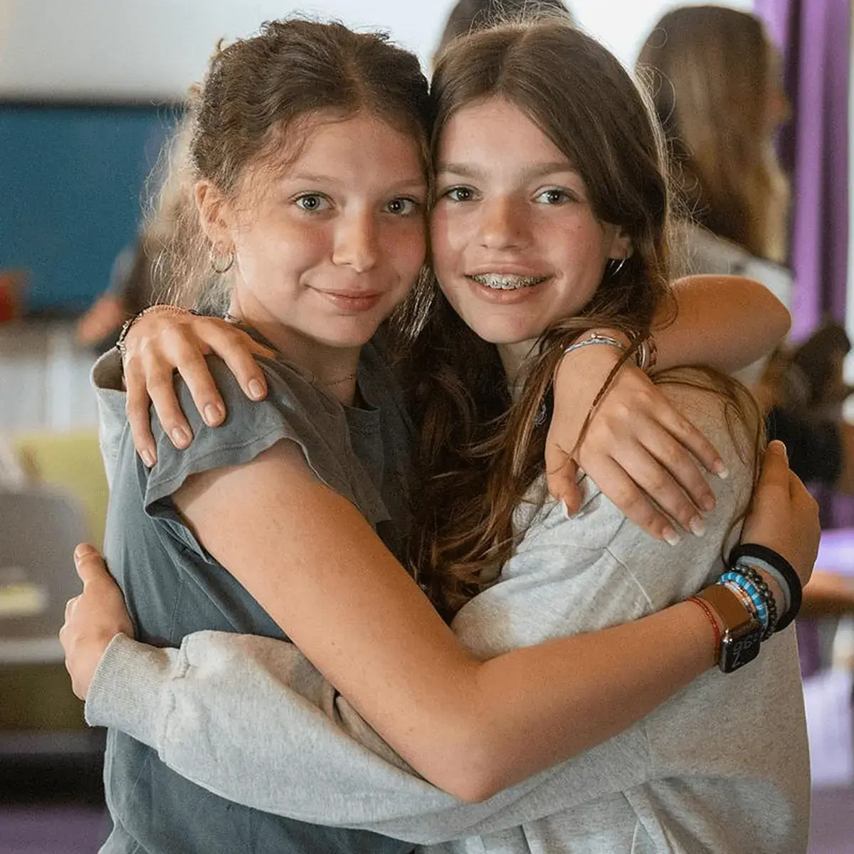 Two Female Students Hugging and Posing For Photo