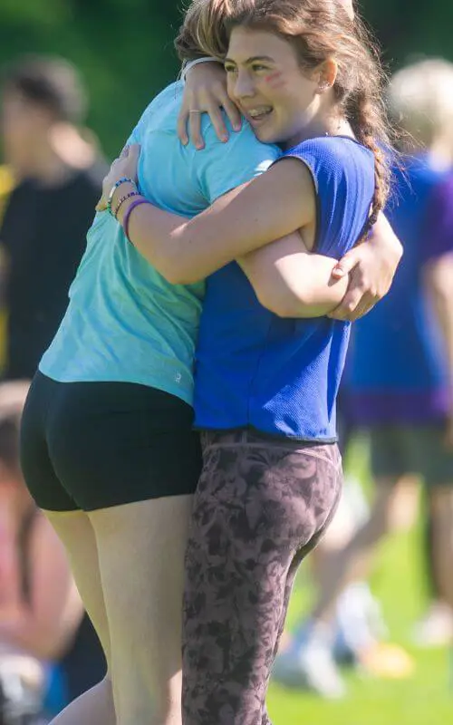 Gordonstoun pupils hugging at an athletics competition