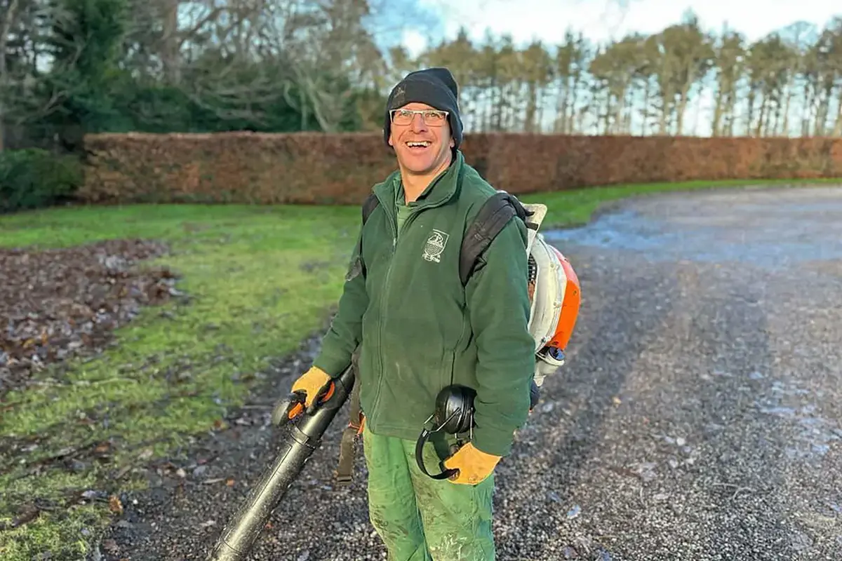 Groundsperson Paul Black Holding a Leaf Blower